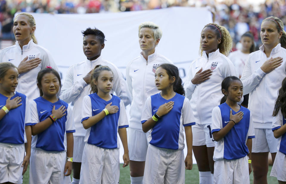 Megan Rapinoe stands during the national anthem, but she refuses to put her hand over her heart. (AP)