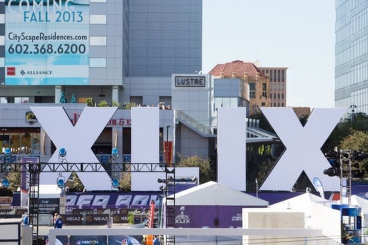 The sun shines on the Super Bowl sign.