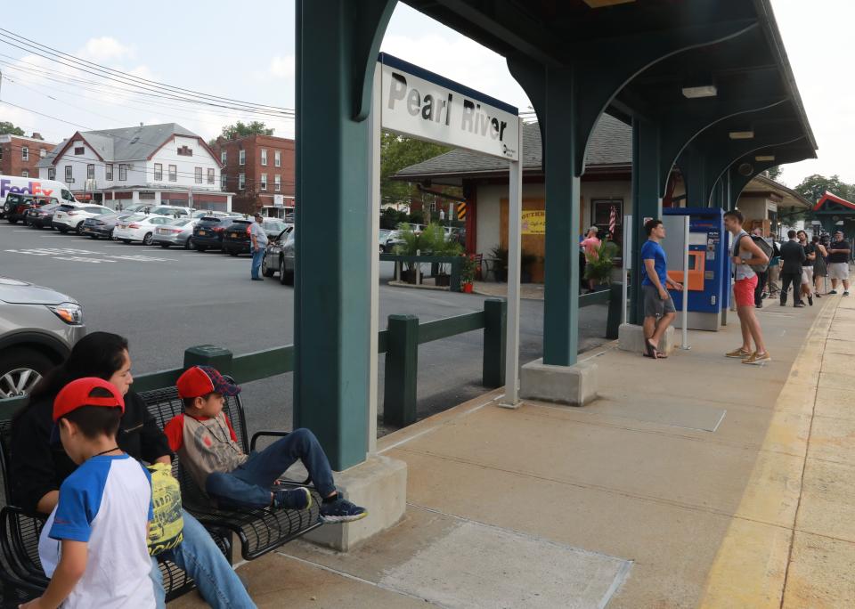 Residents wait for the train to arrive at Pearl River train station on Aug. 15, 2018.