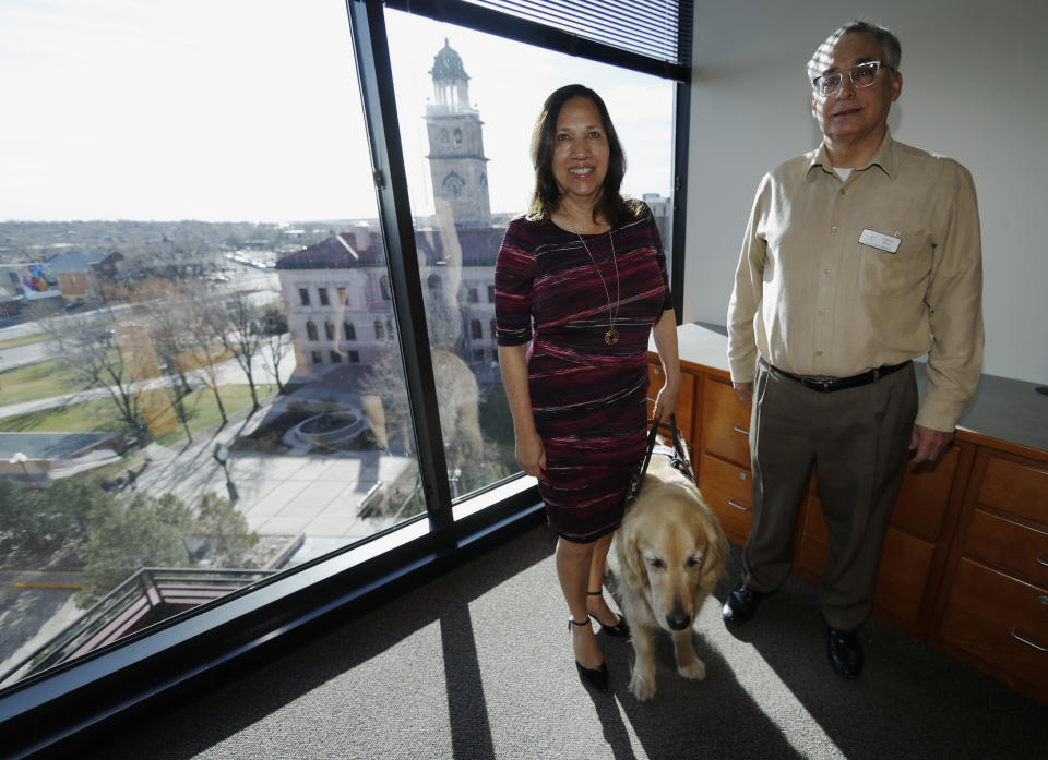 In this Friday, Dec. 13, 2019, photograph, Colorado Springs, Colo., council members Yolanda Avila and Andres Pico are shown in a city office in Colorado Springs, Colo. Hispanic voters are heavily Democratic but Hispanic men are more likely to vote Republican than Hispanic women. This gender gap is roughly the same size as the one among white voters. Avila and Pico are friends who sit next to each other on the Colorado Springs' city council. But politically the two couldn't be further apart, Avila is a durable Democrat and Pico an unflinching Republican. (AP Photo/David Zalubowski)