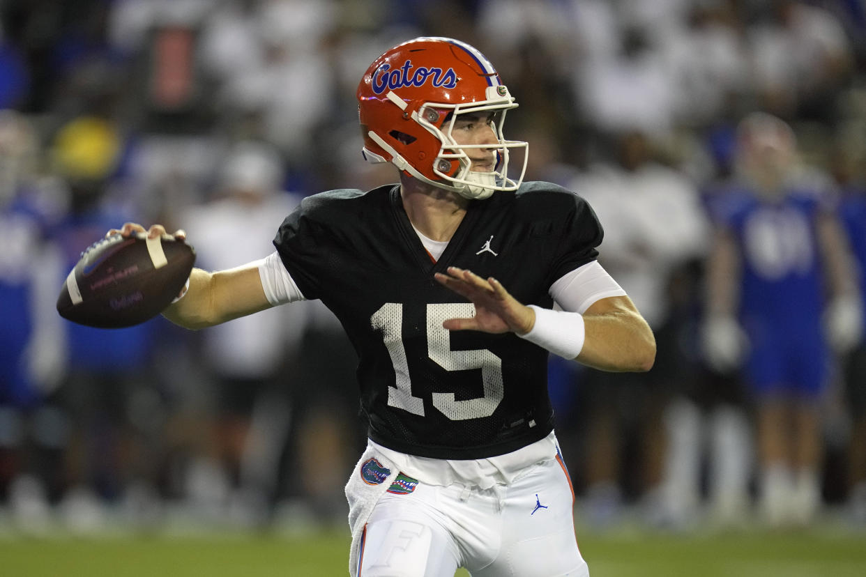 FILE - Florida quarterback Graham Mertz looks for a receiver during the second half of the NCAA college football team's annual Orange and Blue spring game, April 13, 2023, in Gainesville, Fla. (AP Photo/John Raoux, File)