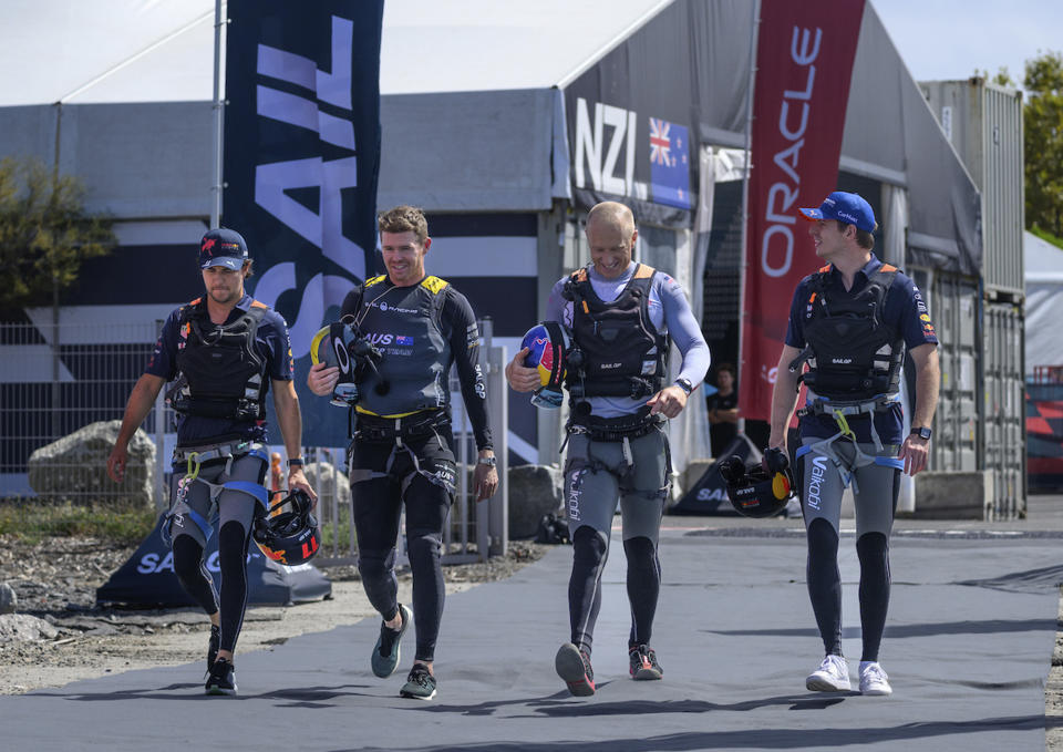 In this photo provided by SailGP, Sergio Perez, left, and Max Verstappen, right, Red Bull Racing Formula One drivers, walk across the Technical Base with Tom Slingsby, CEO and driver of Australia SailGP Team, and Jimmy Spithill, CEO & driver of USA SailGP Team, second from right, after taking part in a 'drag race' ahead of the France Sail Grand Prix in St. Tropez, France, on Sept. 6, 2022. Two of the world's best skippers are trying to reclaim their sea legs before falling further behind in SailGP's race for the $1 million Season 3 championship. (Jon Buckle/SailGP via AP)