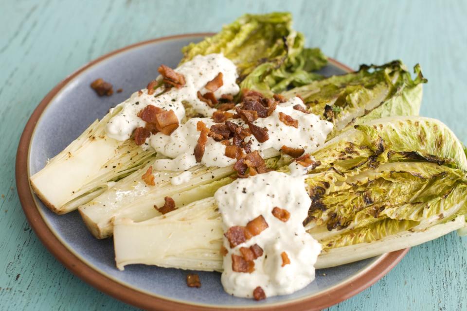 In this image taken on May 13, 2013, grilled hearts of romaine with blue cheese dressing are shown served on a plate in Concord, N.H. (AP Photo/Matthew Mead)