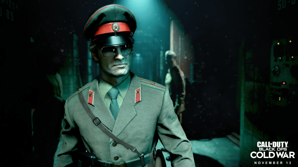Promotional still from ‘Call of Duty: Black Ops Cold War,’ featuring a Soviet leader with a scarred face walking through a dark and ominous environment.