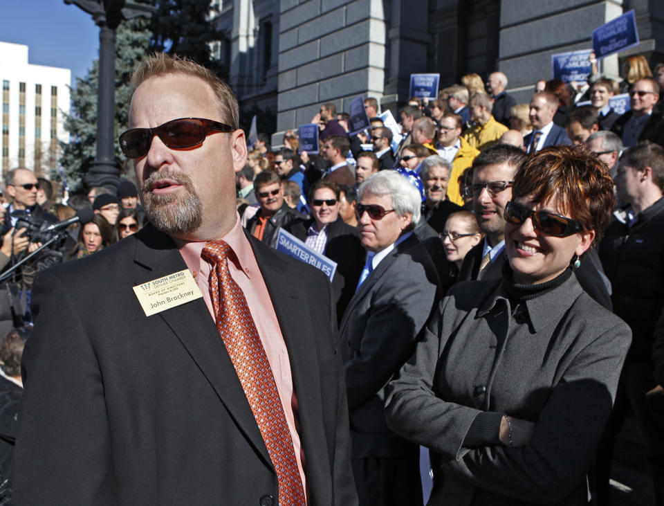 John Brackney, left, President and CEO of the South Metro Chamber of Commerce and Kelly Brough, right, President and CEO of the Denver Metro Chamber of Commerce look over the crowd of supporters during a rally at the Capitol in Denver on Tuesday, Nov. 13, 2012. Brackney and Brough were among the speakers at the rally in support of fracking. (AP Photo/Ed Andrieski)