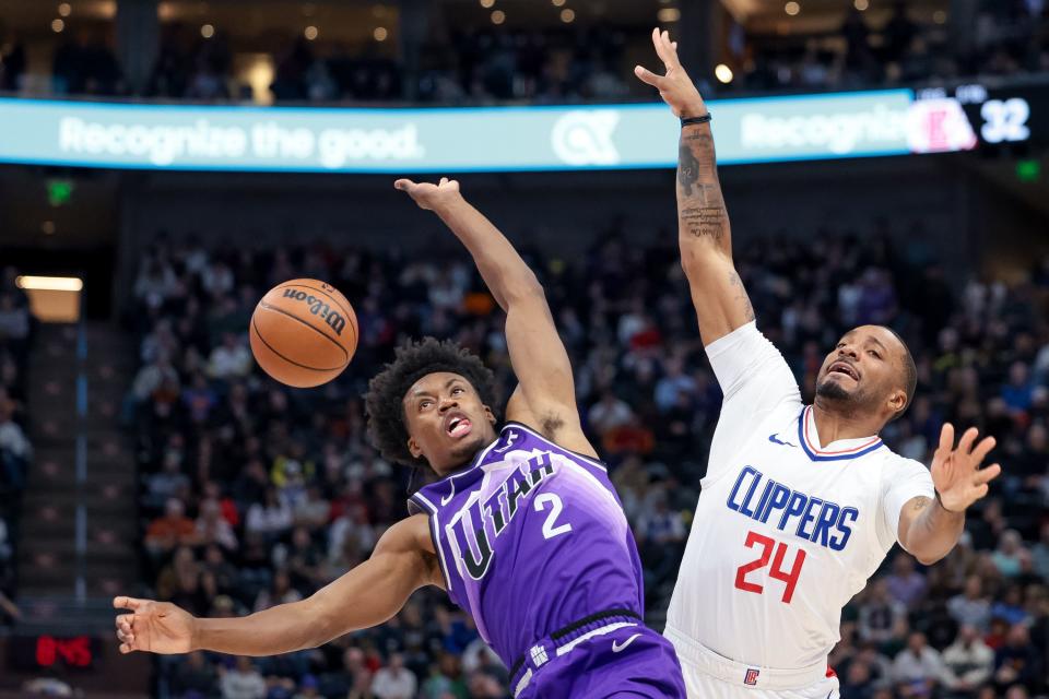 Utah Jazz guard Collin Sexton (2) draws the foul against LA Clippers guard Norman Powell (24) at the Delta Center in Salt Lake City on Friday, Dec. 8, 2023. | Spenser Heaps, Deseret News