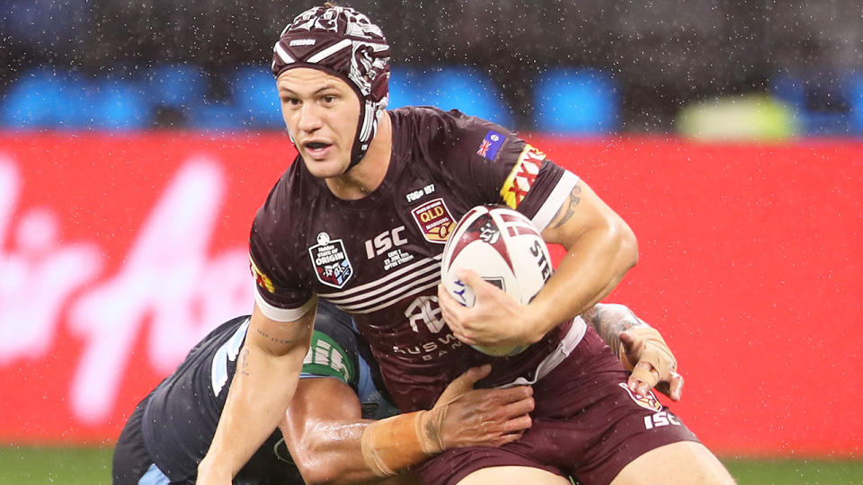 Pictured here, Kalyn Ponga is tackled in Origin playing for Queensland.