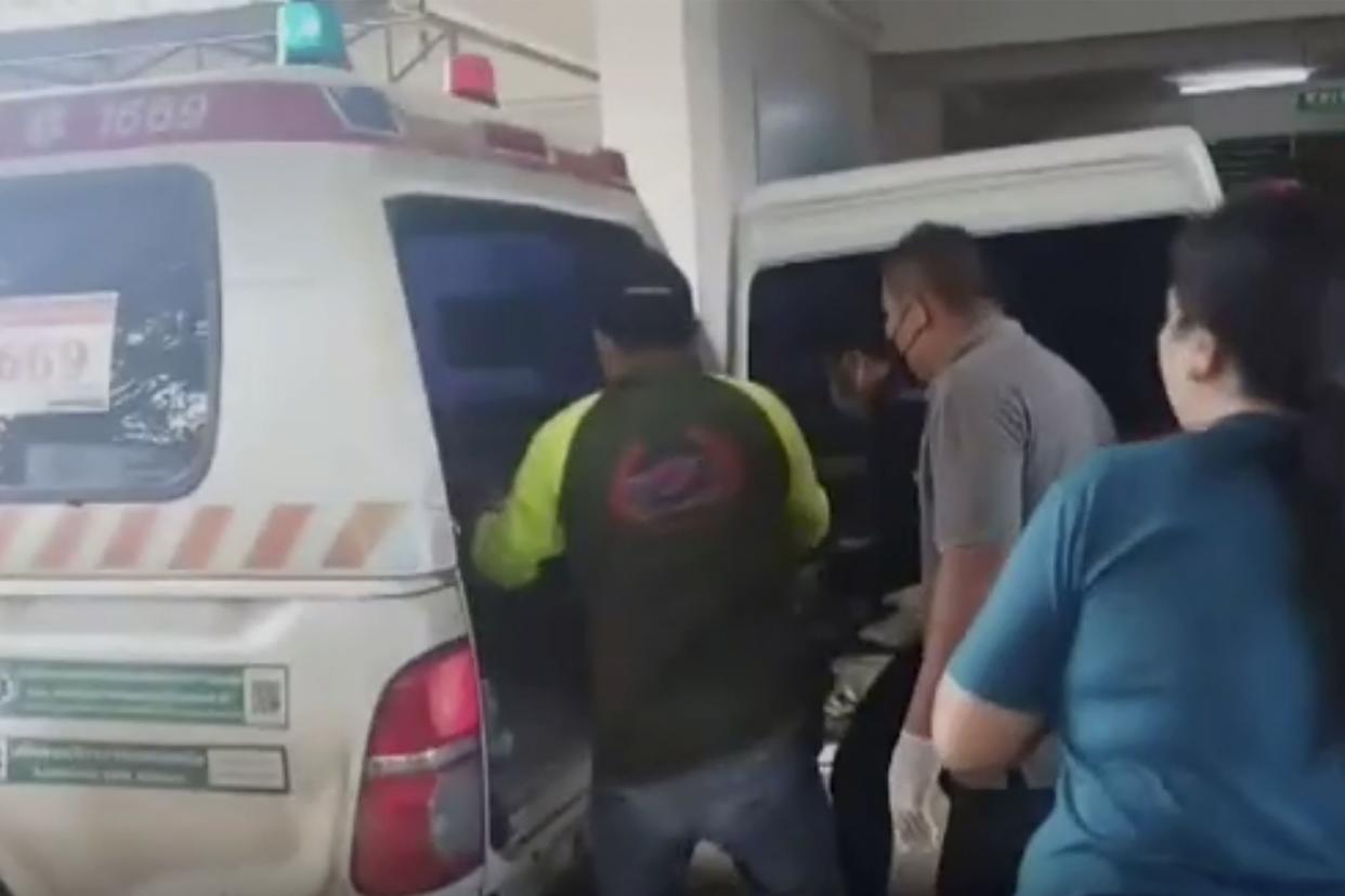 In this image taken from video, an ambulance is loaded at the site of an attack at a daycare center, Thursday, Oct. 6, 2022, in the town of Nongbua Lamphu, northeastern Thailand. More than 30 people, primarily children, were killed Thursday when a gunman opened fire in childcare center, authorities said.