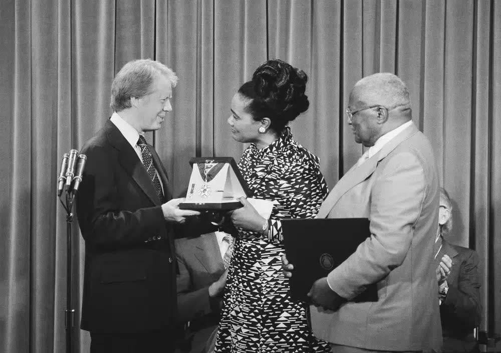 President Jimmy Carter, left, presents the Medal of Freedom Award to Coretta King, wife of the late Martin Luther King Jr., during a ceremony at the White House in Washington on Monday, July 13, 1977. (AP Photo/John Duricka, File)