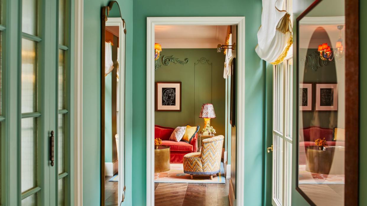 a hallway with green doors