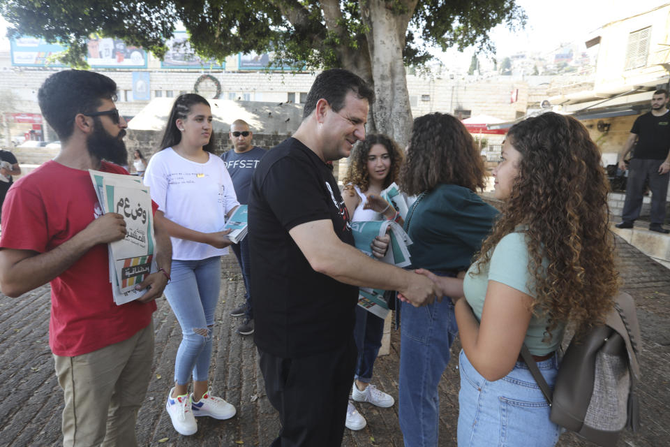 In this Thursday, Aug. 29, 2019 photo, Ayman Odeh, the leader of the Arab Joint List parties, meets constituents in Nazareth, Israel. Odeh has shaken up Israel's election campaign by offering to sit in a moderate coalition government _ a development that would upend decades of convention that has relegated Arab parties to the sidelines and could bring down Prime Minister Benjamin Netanyahu. (AP Photo/Mahmoud Illean)