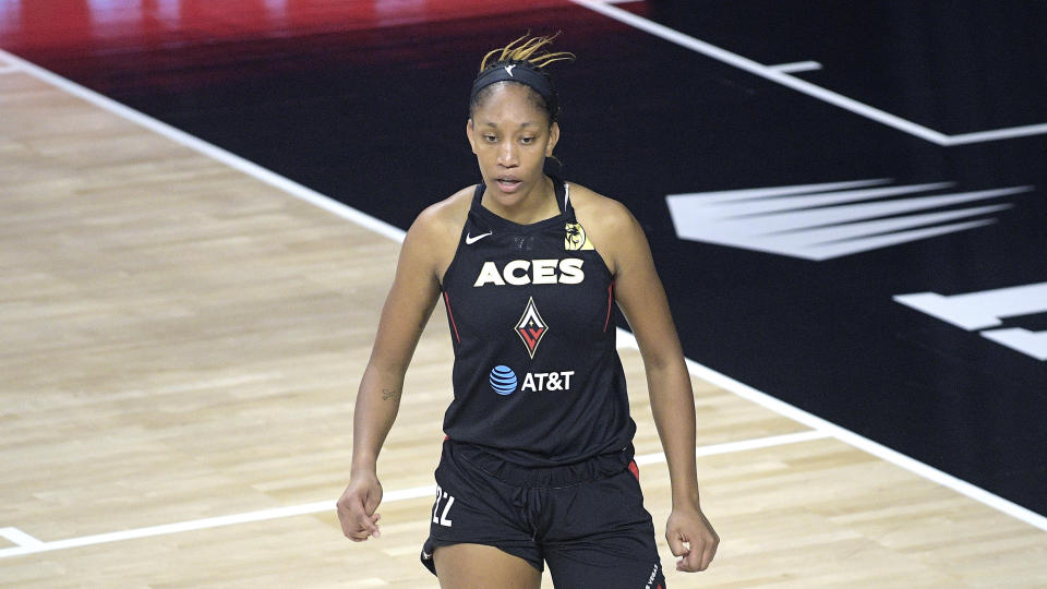 A'ja Wilson in a black Aces uniform on the court. 