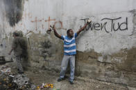 An anti-government protester yells during clashes with security forces as some residents show support for an apparent mutiny by a national guard unit in the Cotiza neighborhood of Caracas, Venezuela, Monday, Jan. 21, 2019. (AP Photo/Fernando Llano)