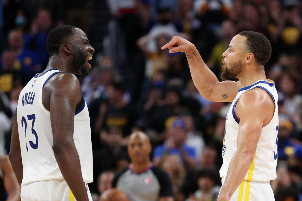 SAN FRANCISCO, CALIFORNIA - MAY 09: Stephen Curry #30 and Draymond Green #23 of the Golden State Warriors celebrate in the final minute of their victory over the Memphis Grizzlies in Game Four of the Western Conference Semifinals of the NBA Playoffs at Chase Center on May 09, 2022 in San Francisco, California.  NOTE TO USER: User expressly acknowledges and agrees that, by downloading and/or using this photograph, User is consenting to the terms and conditions of the Getty Images License Agreement.  (Photo by Ezra Shaw/Getty Images)