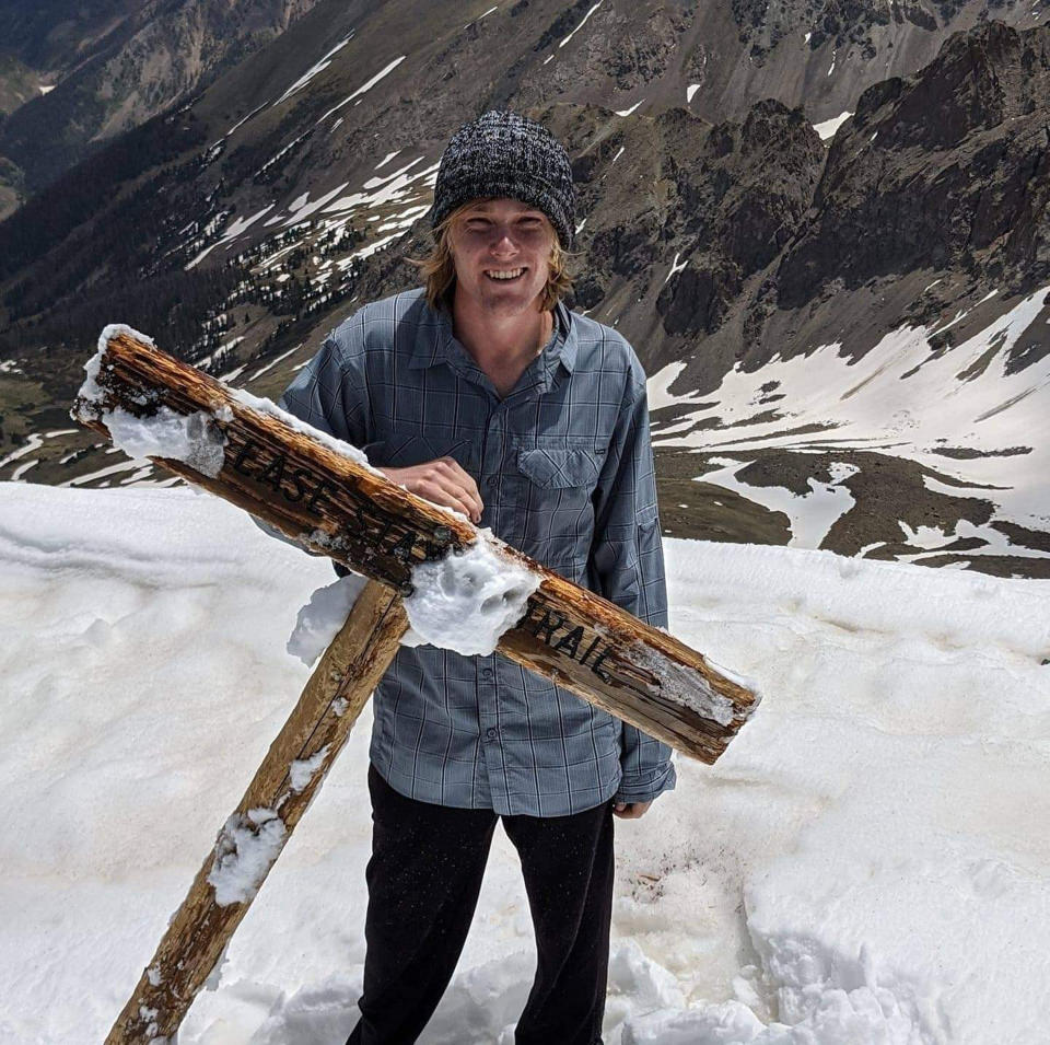 In this June 2020, photo provided by Jean Granberg, her son Daniel Granberg poses at the top of the summit of Handies, a mountain peak of over fourteen thousand feet, in the San Juan Mountains in Colorado. The body of the American man, who died while climbing one of Bolivia’s highest peaks, arrived Sunday, Sept. 5, 2021, in the country’s capital after a two-day recovery effort. Rescue workers said 24-year-old Granberg, of Colorado, died atop the Illimani mountain. (Jean Granberg via AP)