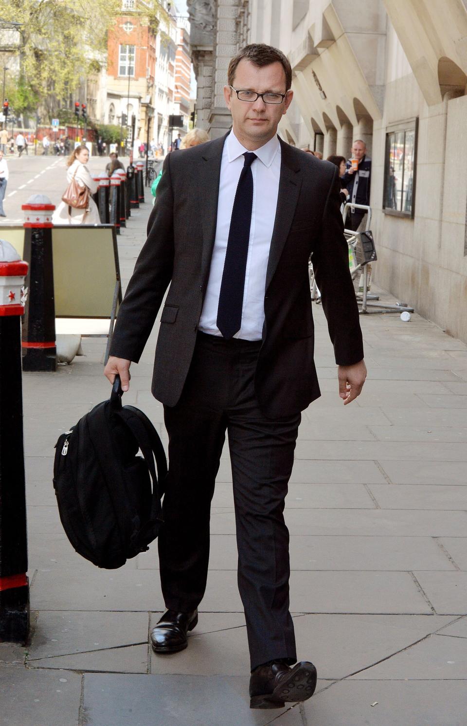 Former News of the World Editor Andy Coulson leaves the Old Bailey, central London, as the phone hacking trial continues Monday April 14, 2014. Coulson said his affair with fellow executive Rebekah Brooks was wrong, but didn't lead him to break editorial standards. Coulson told jurors at London’s Central Criminal Court Monday that the on-off affair, which began in 1998, "was wrong and it shouldn't have happened."(AP Photo/John Stillwell/PA) UNITED KINGDOM OUT