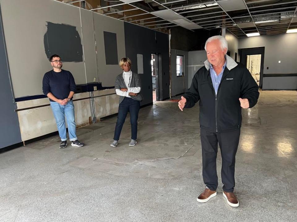 Ted Swaldo is shown inside the former Ziegler Tire building in downtown Canton. Swaldo and Bluecoats are assisting EN-RICH-MENT Fine Arts Academy with renovating and expanding the property as part of a $1.75 million project. Shown in the background are Mike Scott of Bluecoats and Betty Smith of EN-RICH-MENT.