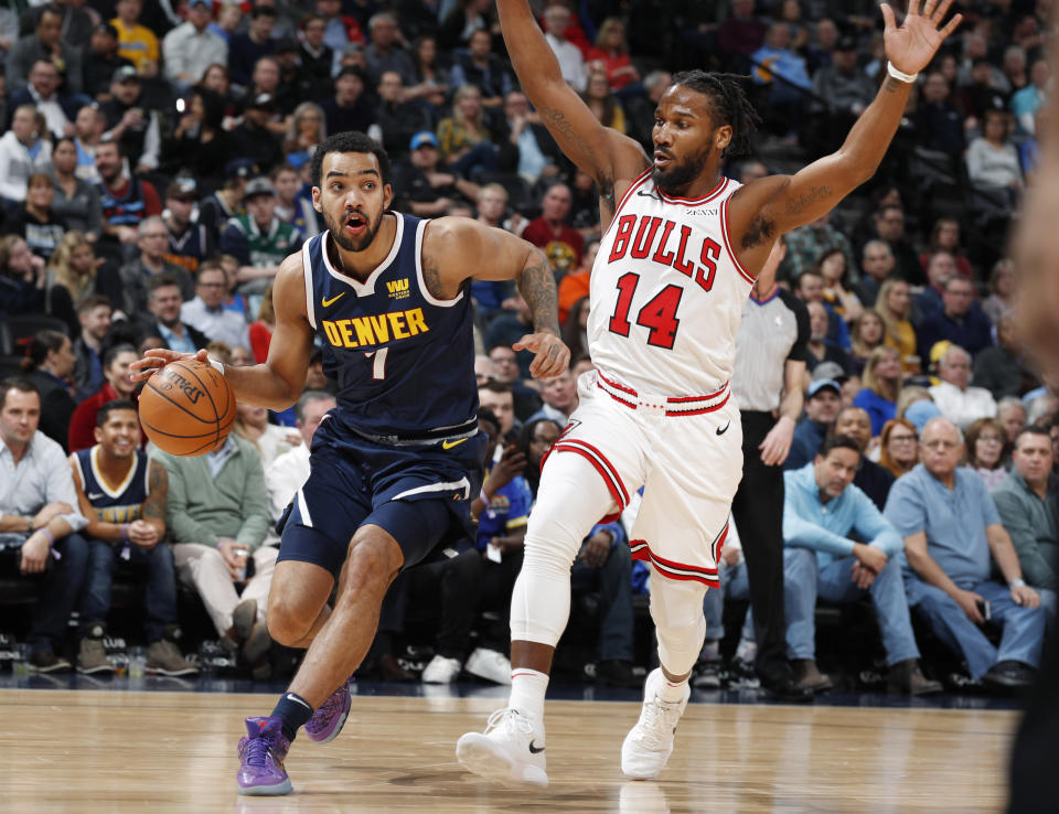 Denver Nuggets forward Trey Lyles, left, drives past Chicago Bulls forward Wayne Selden Jr. in the first half of an NBA basketball game, Thursday, Jan. 17, 2019, in Denver. (AP Photo/David Zalubowski)