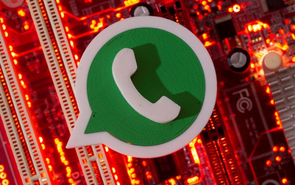 A 3D printed Whatsapp logo is placed on a computer motherboard - Dado Ruvic/Reuters