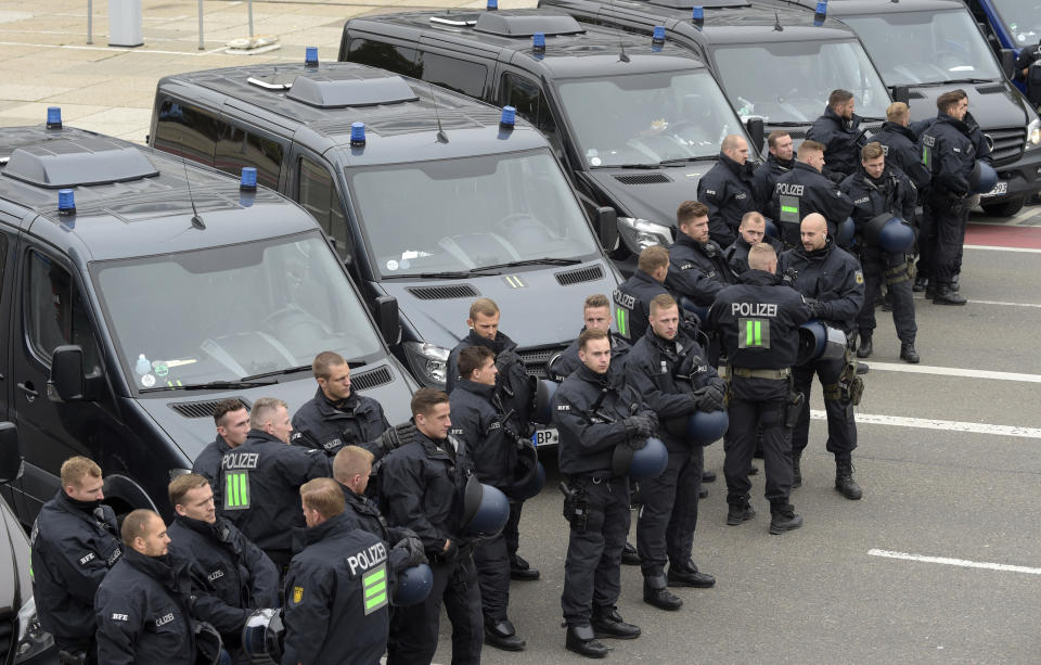 Police officers prepare for a demonstration in Chemnitz, eastern Germany, Saturday, Sept. 1, 2018, after several nationalist groups called for marches protesting the killing of a German man last week, allegedly by migrants from Syria and Iraq. (AP Photo/Jens Meyer)