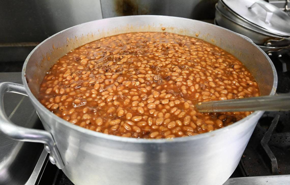 A pot of baked beans made on site with a special barbecue sauce simmers in the Smoking Woods food truck in Fresno’s Brewery District in downtown Fresno on Friday, Dec. 9, 2022.