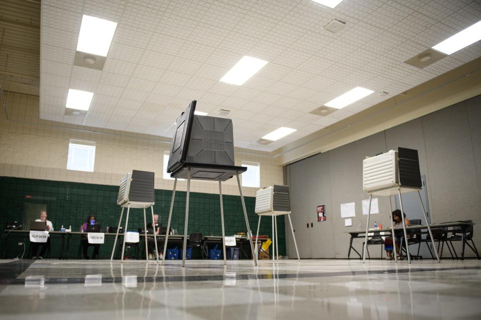 Election officials wait for voters at a polling site at Smith Recreation Center on Tuesday, July 26, 2022.