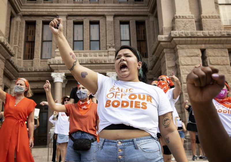 FILE - Leen Garza participates in a protest with others against the six-week abortion ban at the Capitol in Austin, Texas, on Wednesday, Sept. 1, 2021. The Justice Department is asking a federal court in Texas to issue a temporary restraining order or a preliminary injunction against a new state law that bans most abortions in Texas. The emergency motion filed Tuesday night, Sept. 14 says a court can issue such an order as a means of preventing harm to parties involved before the court can fully decide the claims in the case. (Jay Janner/Austin American-Statesman via AP, File)