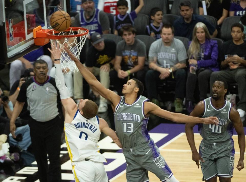Sacramento Kings forward Keegan Murray (13) defends basket from Golden State Warriors guard Donte DiVincenzo (0) during Game 5 of the first-round NBA playoff series at Golden 1 Center on Wednesday.