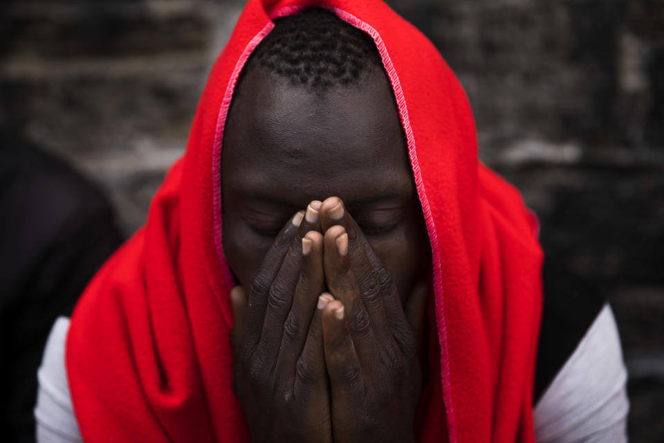 FILE - In this June 27, 2018 file photo, a migrant rests at the port of Tarifa, southern Spain, as he waits to be transported to a police station after being rescued by Spain's Maritime Rescue Service in the Strait of Gibraltar. Spain appears to have stemmed a surge in illegal migration that made it the main Mediterranean entry point for migrants seeking ways into Europe by increasing Morocco's involvement in border control. (AP Photo/Emilio Morenatti, File)