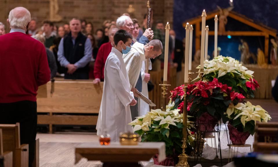 Father Matthew Widder, center, is shown during Christmas Eve mass Friday, December 24, 2021 at St. William Catholic Church in Waukesha, Wis. St. William is one of four parishes that make up the â€œCatholic Community of Waukeshaâ€. Several of their members were struck and seriously injured Nov. 21, when a man driving a red Ford Escape plowed into the city's annual Christmas parade, leaving six dead and more than 60 injured.