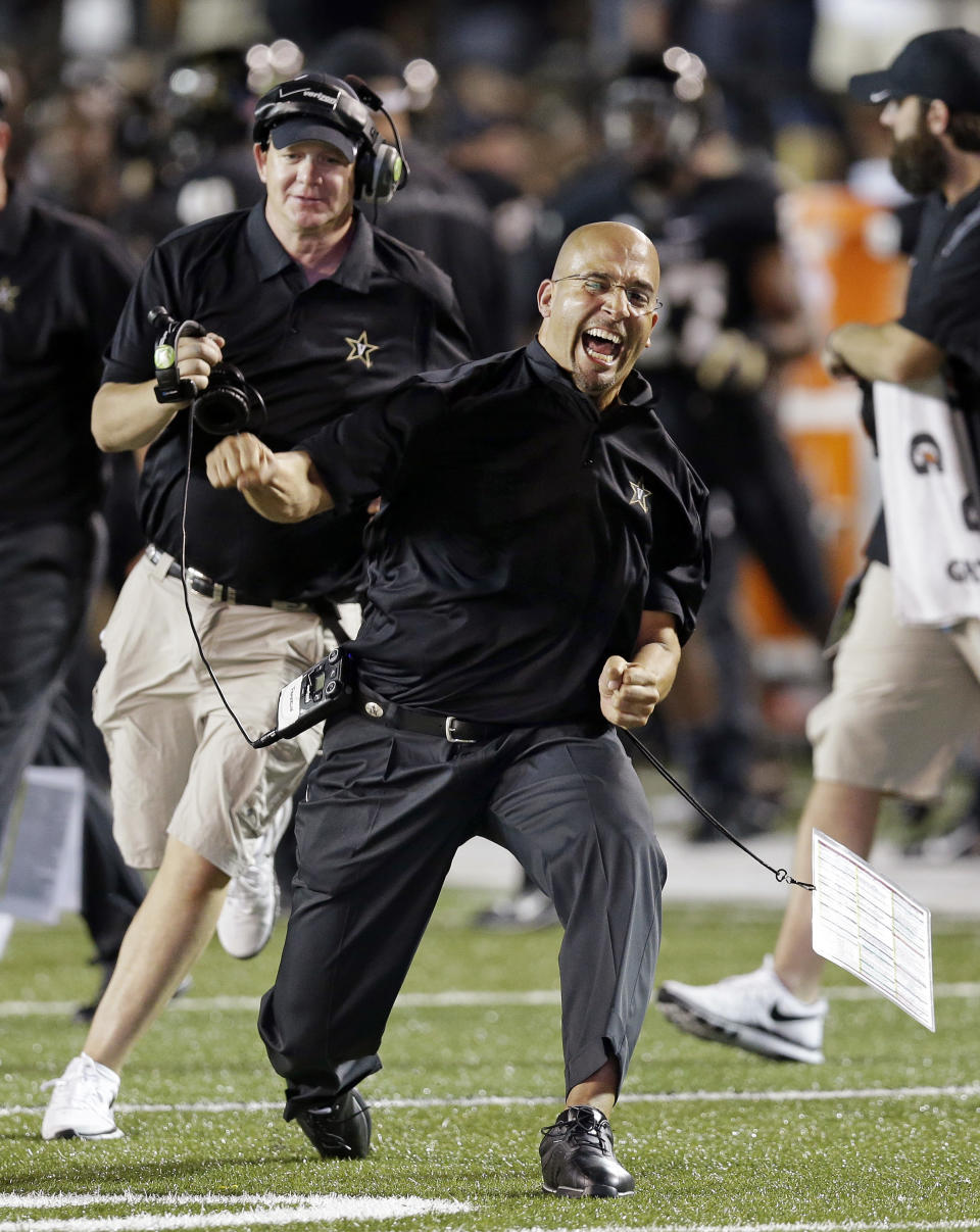 FILE - In this Aug. 30, 2013 file photo, Vanderbilt head coach James Franklin, center, celebrates after Vanderbilt took the lead against Mississippi during the fourth quarter of an NCAA college football game in Nashville, Tenn. Penn State has hired Franklin as its next head coach. Franklin, 41, who led Vanderbilt to bowls in all three of his seasons there, replaces Bill O'Brien, who left the Nittany Lions after two years to coach the NFL's Houston Texans. Penn State made the announcement Saturday, after the school's compensation committee met to finalize the contract. (AP Photo/Mark Humphrey, File)