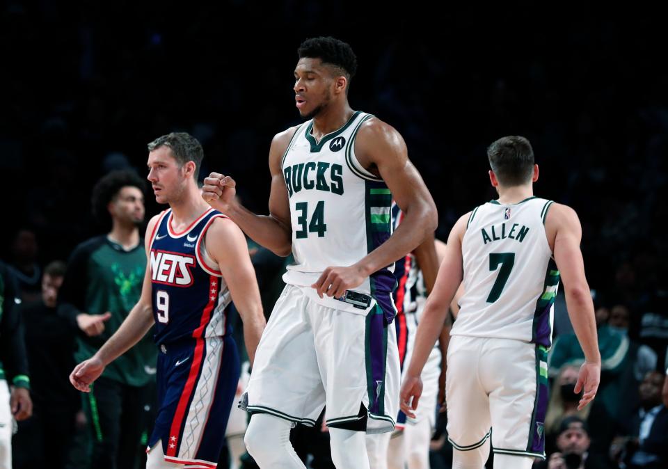 Milwaukee Bucks forward Giannis Antetokounmpo (34) reacts after scoring against the Brooklyn Nets during the second half of an NBA basketball game Thursday, March 31, 2022, in New York. The Bucks won 120-119 in overtime. (AP Photo/Noah K. Murray)
