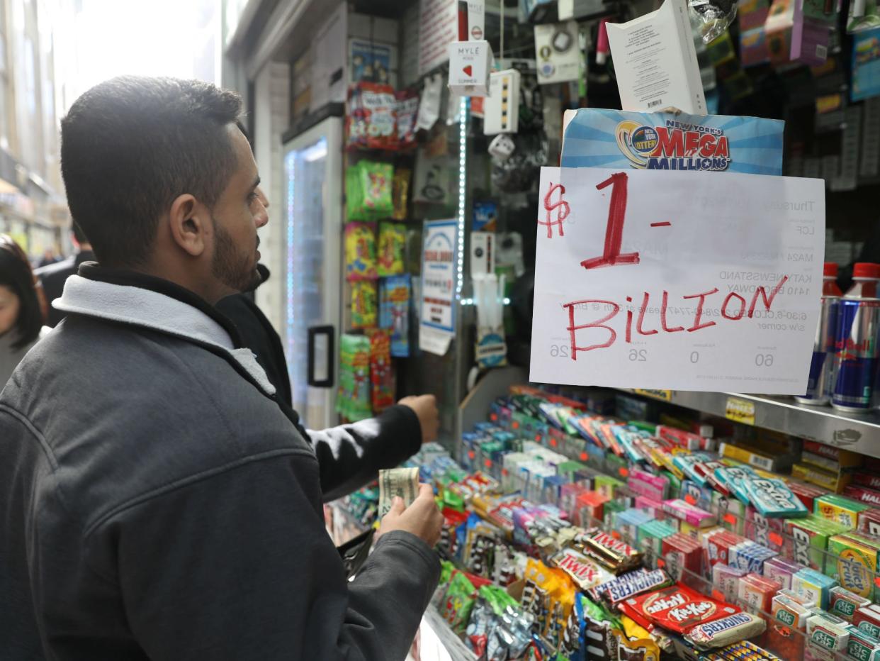 Customers line up to buy Mega Millions tickets at a newsstand in midtown Manhattan, New York: Mike Sugar/Reuters