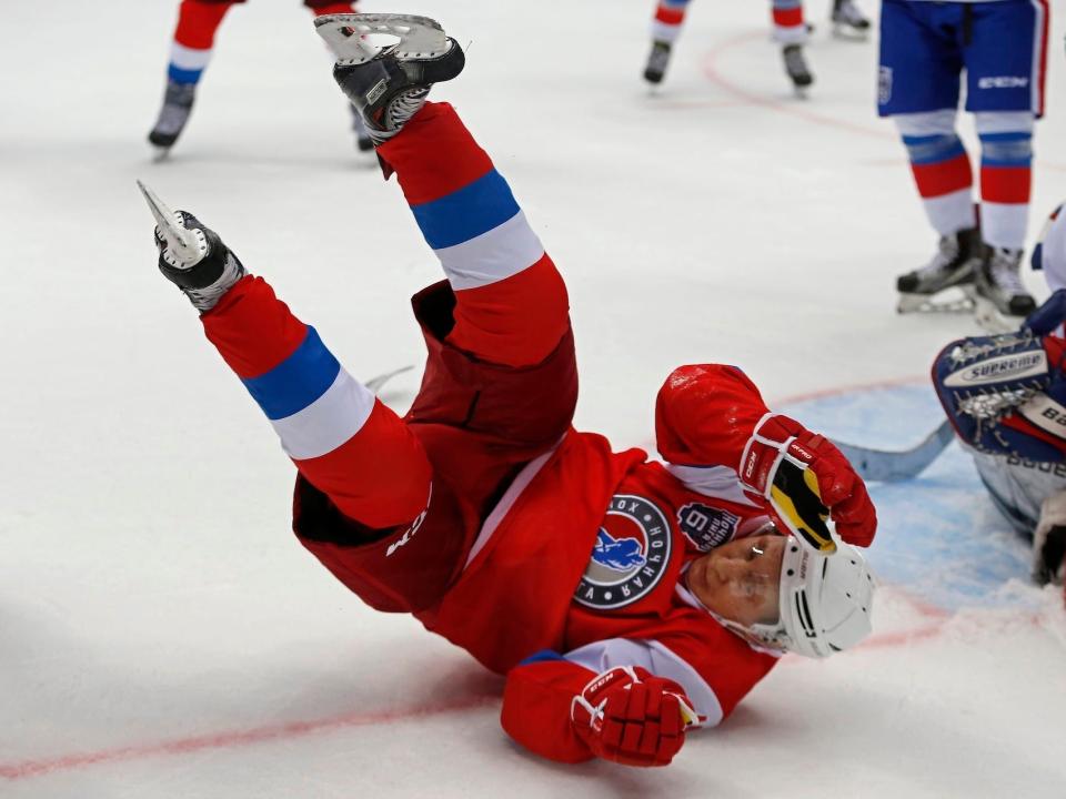 President Vladimir Putin, in ice hockey gear, falling on his back in a match in Sochi, Russia, in 2017.