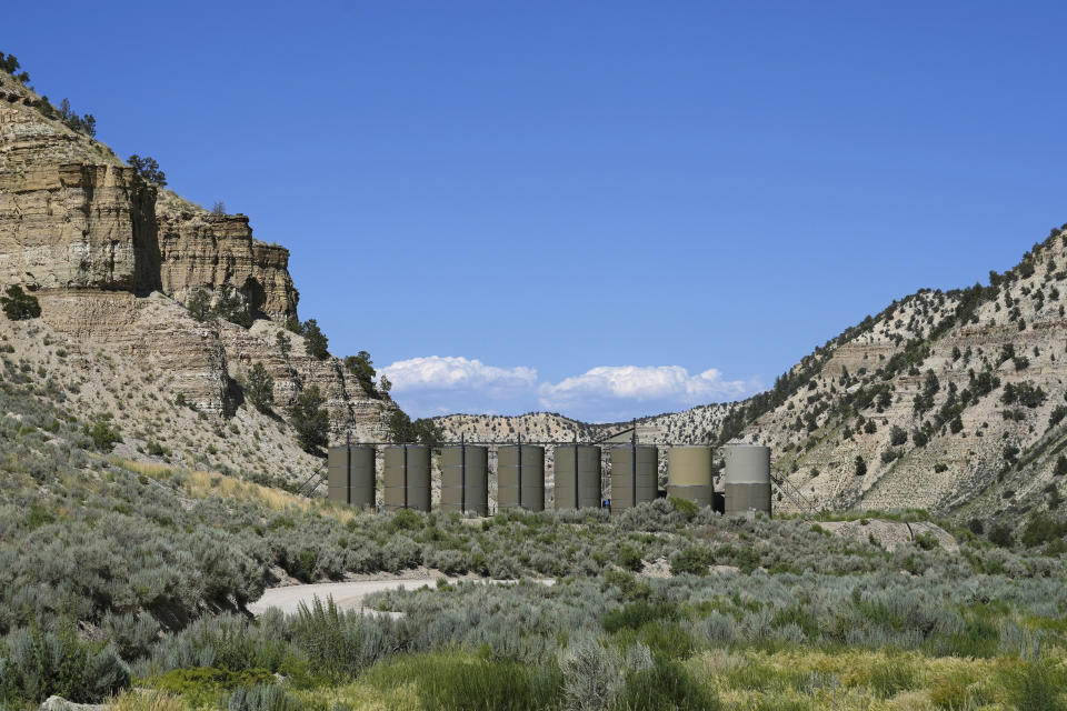 FILE - Oil sits in containers at a facility on public lands south of Duchesne, Utah on Thursday, July 13, 2023. The Supreme Court has agreed to consider reviving a critical approval for a railroad project that would carry crude oil and boost fossil fuel production in rural eastern Utah. The justices said Monday they will review an appeals court ruling that overturned the approval issued by the Surface Transportation Board for the Uinta Basin Railway, an 88-mile railroad line. (AP Photo/Rick Bowmer, File)