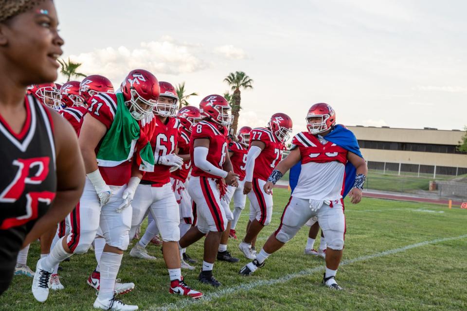Palm Springs High football team gets pumped up before kickoff against Granite Hills in Palm Springs, Calif., on Friday, August 18, 2023.