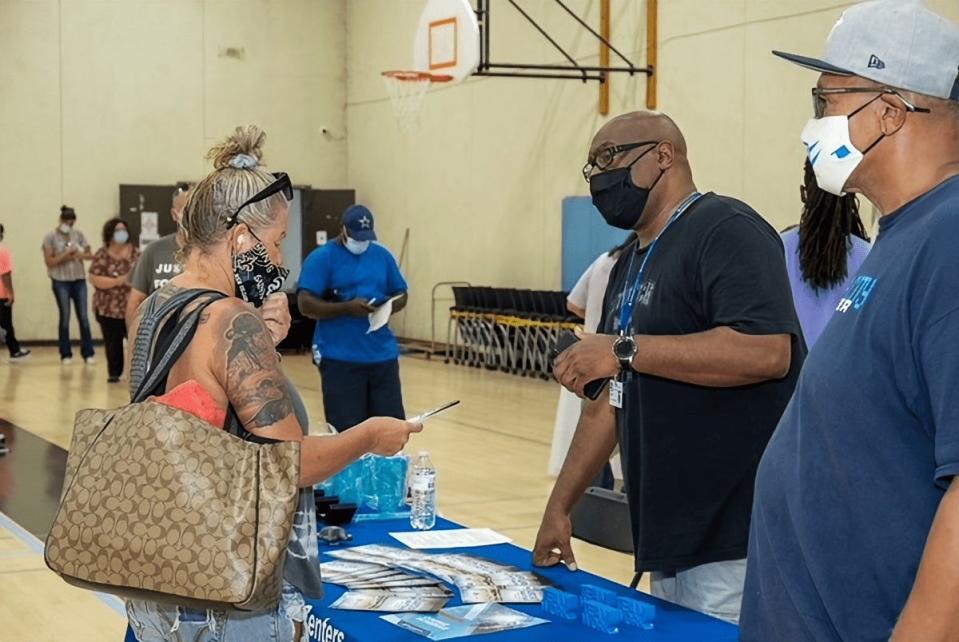 A representative from MetroTech provides information to an attendee of the Urban League of Greater Oklahoma City's expungement fair on Aug. 21, 2021.