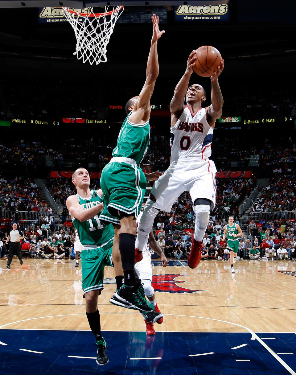 ATLANTA, GA - MAY 01: Jeff Teague #0 of the Atlanta Hawks drives against Sasha Pavlovic #11 and Avery Bradley #0 of the Boston Celtics in Game Two of the Eastern Conference Quarterfinals in the 2012 NBA Playoffs at Philips Arena on May 1, 2012 in Atlanta, Georgia. NOTE TO USER: User expressly acknowledges and agrees that, by downloading and or using this photograph, User is consenting to the terms and conditions of the Getty Images License Agreement. (Photo by Kevin C. Cox/Getty Images)