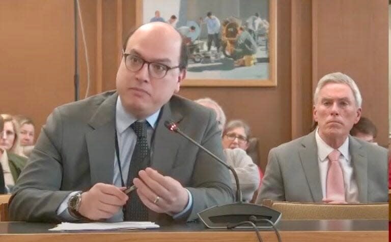 Dr. Jeffrey Fetter, medical director at the New Hampshire Hospital, testifies in favor of legislation that would add certain mental health records to gun background checks. Rep. David Meuse, a Portsmouth Democrat who co-sponsored the bill, looks on.