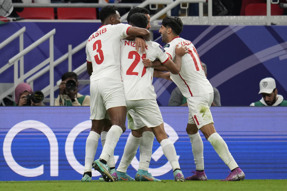 Jordan's Yazan Alnaimat, right, celebrates after scoring his side's opening goal during the Asian Cup semifinal soccer match between South Korea and Jordan at Ahmad Bin Ali Stadium in Al Rayyan, Qatar, Tuesday, Feb. 6, 2024. (AP Photo/Aijaz Rahi)