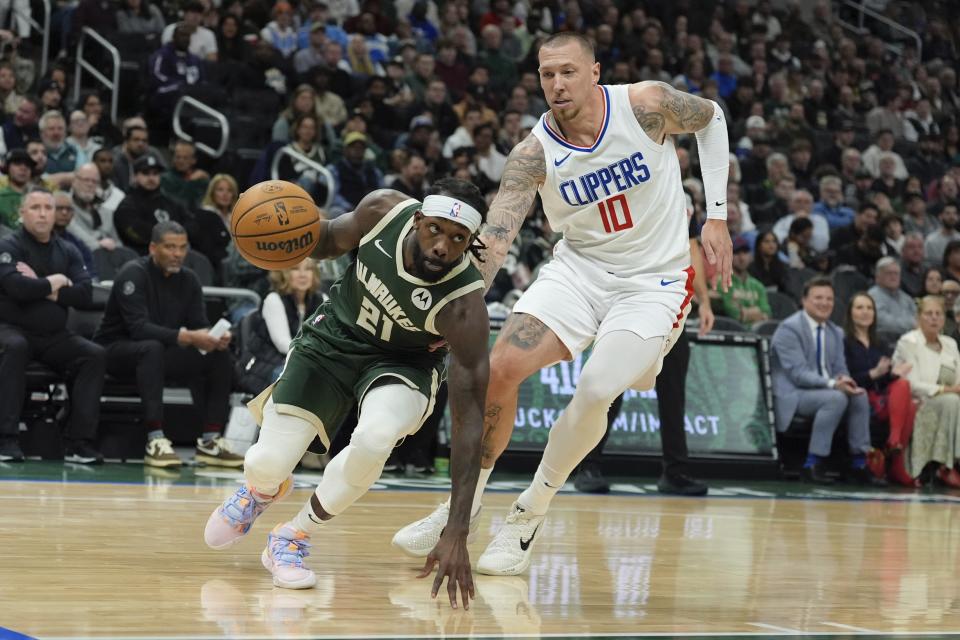 Milwaukee Bucks' Patrick Beverley gets past LA Clippers' Daniel Theis during the first half of an NBA basketball game Monday, March 4, 2024, in Milwaukee. (AP Photo/Morry Gash)