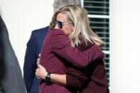 Hollie Skaggs, right, is hugged after a prayer vigil at the Collierville Town Hall Friday, Sept. 24, 2021, in Collierville, Tenn. Skaggs was shopping in a Kroger grocery store Thursday when a gunman attacked people, killing one and injuring others, before he was found dead of an apparent self-inflicted gunshot wound. (AP Photo/Mark Humphrey)