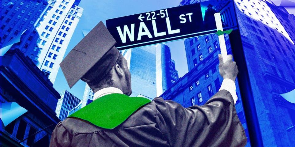 A new grad facing the Wall Street sign.