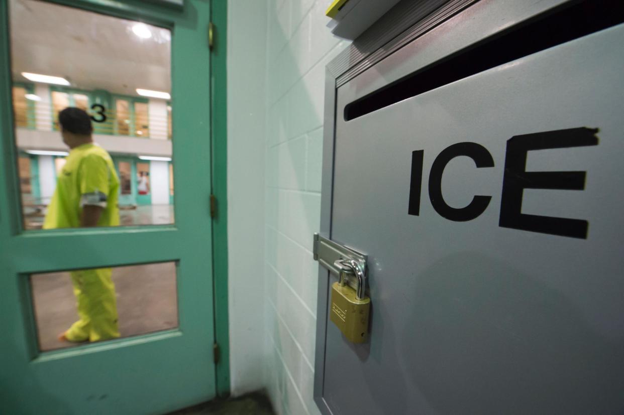 An immigration detainee stands near an US Immigration and Customs Enforcement (ICE) grievance box at an unrelated facility: ROBYN BECK/AFP/Getty Images