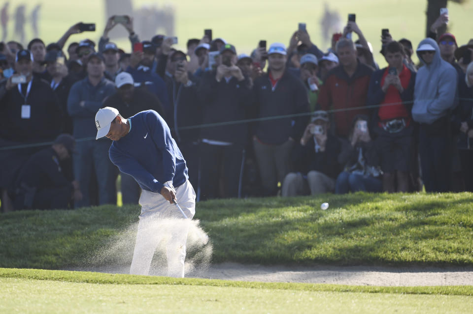 Tiger Woods hits out of the bunker on the first hole of the South Course at Torrey Pines Golf Course during the third round of the Farmers Insurance golf tournament Saturday Jan. 25, 2020, in San Diego. (AP Photo/Denis Poroy)