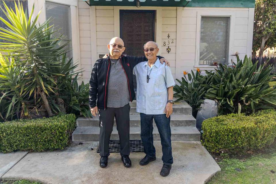 <p>Courtesy of San Diego State University</p> Lloyd Dong Jr. (left) and his brother Ron stand outside of their childhood home on C Street in Coronado