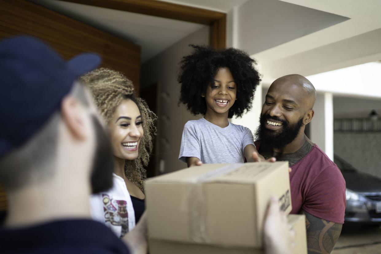 Family receiving a delivery from the mailman