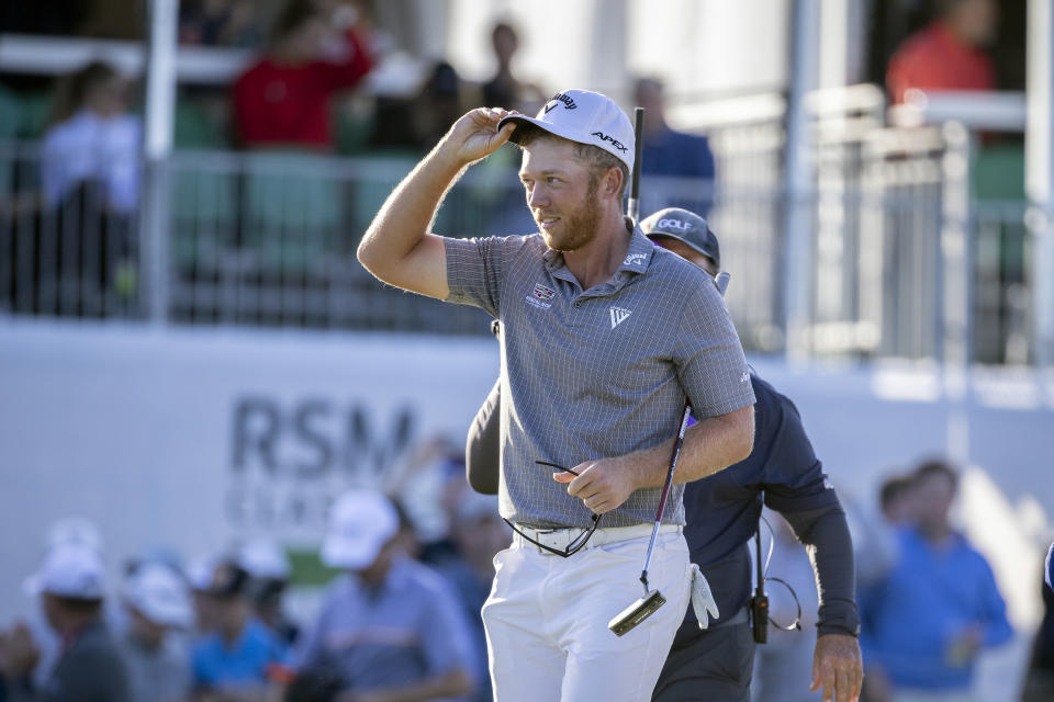 Talor Gooch tips his hat to the crowd after sinking his par putt on the 18th hole during the final round of the RSM Classic golf tournament, Sunday, Nov. 21, 2021, in St. Simons Island, Ga. (AP Photo/Stephen B. Morton)