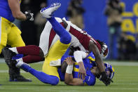 Arizona Cardinals outside linebacker Markus Golden, top, sacks Los Angeles Rams quarterback Matthew Stafford during the first half of an NFL wild-card playoff football game in Inglewood, Calif., Monday, Jan. 17, 2022. (AP Photo/Mark J. Terrill)