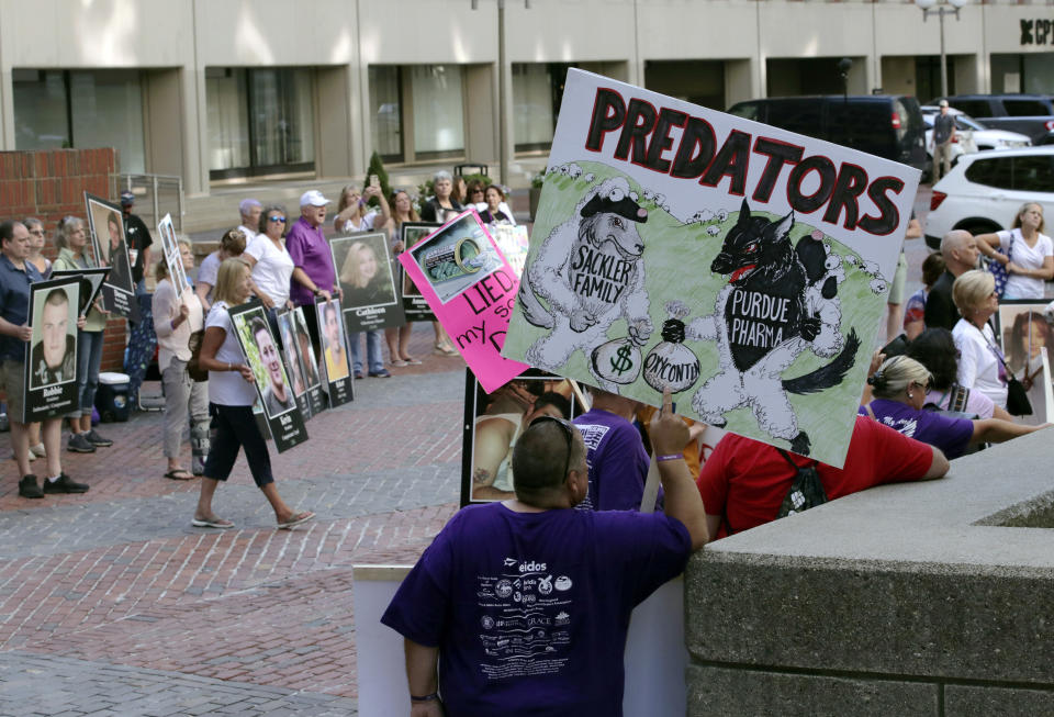 Protesters gather outside a courthouse on Friday, Aug. 2, 2019, in Boston, where a judge was to hear arguments in Massachusetts' lawsuit against Purdue Pharma over its role in the national drug epidemic. Organizers said they wanted to continue to put pressure on the Connecticut pharmaceutical company and the Sackler family that owns it. (AP Photo/Charles Krupa)